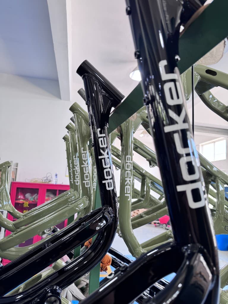 Black and Jungle Green Docker frames on the production rack